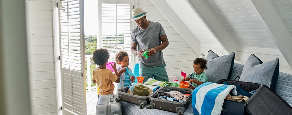 A family unpacking their suitcase on vacation