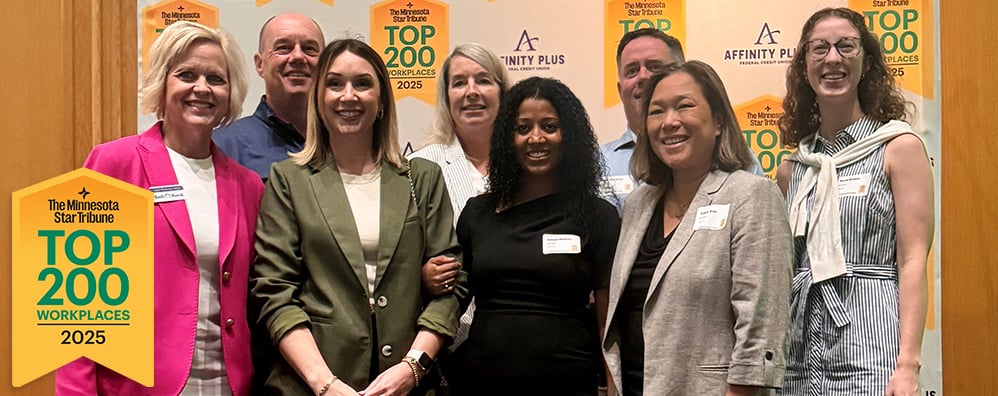 Bell Bank employees in front of "Minnesota Star Tribune Top 200 Workplaces 2025" photo backdrop