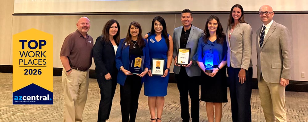 Group of Bell Bank employees with a few in the middle holding Arizona Central Top Workplaces award