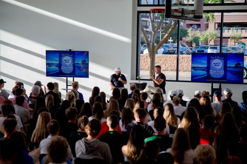 Two speakers talking to a group of people
