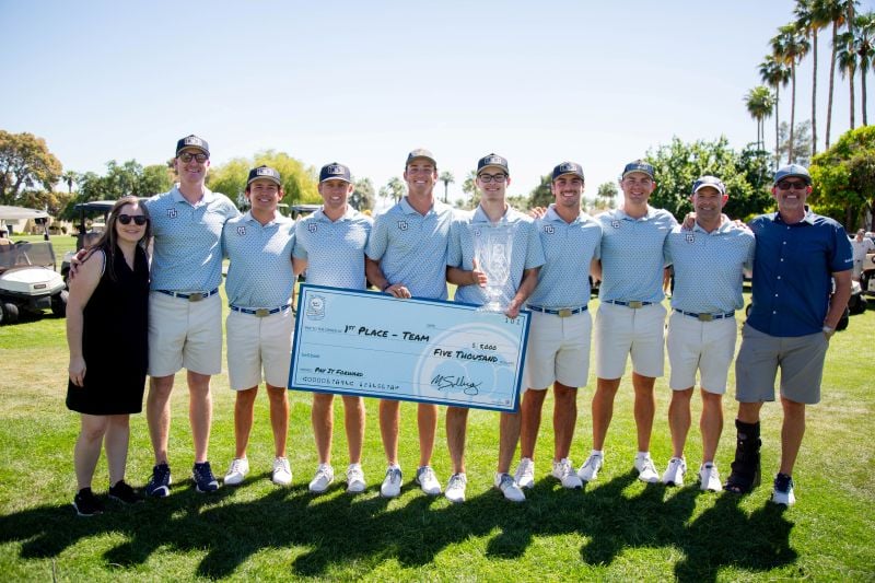 Golf team photo with the trophy and the pay it forward check