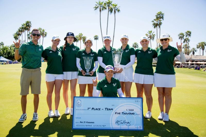 Golf team photo with the trophy and the pay it forward check