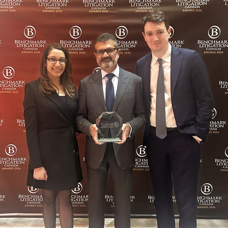 Preet Gill, Munaf Mohamed and Doug Fenton pose with a glass Benchmark Litigation Canada award.