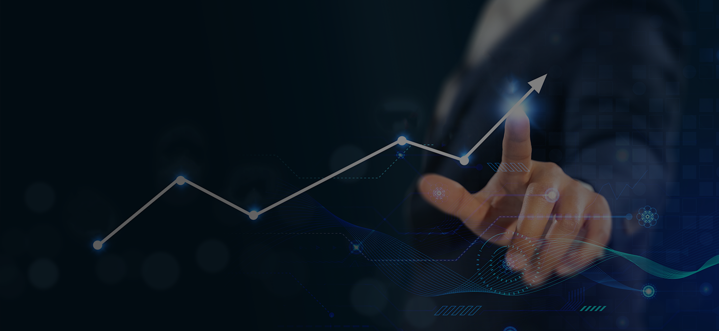 A businessman points at a graph displaying an upward arrow, indicating growth or positive trends in data.