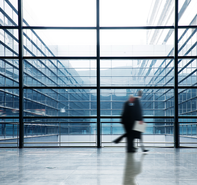 People walking past large window