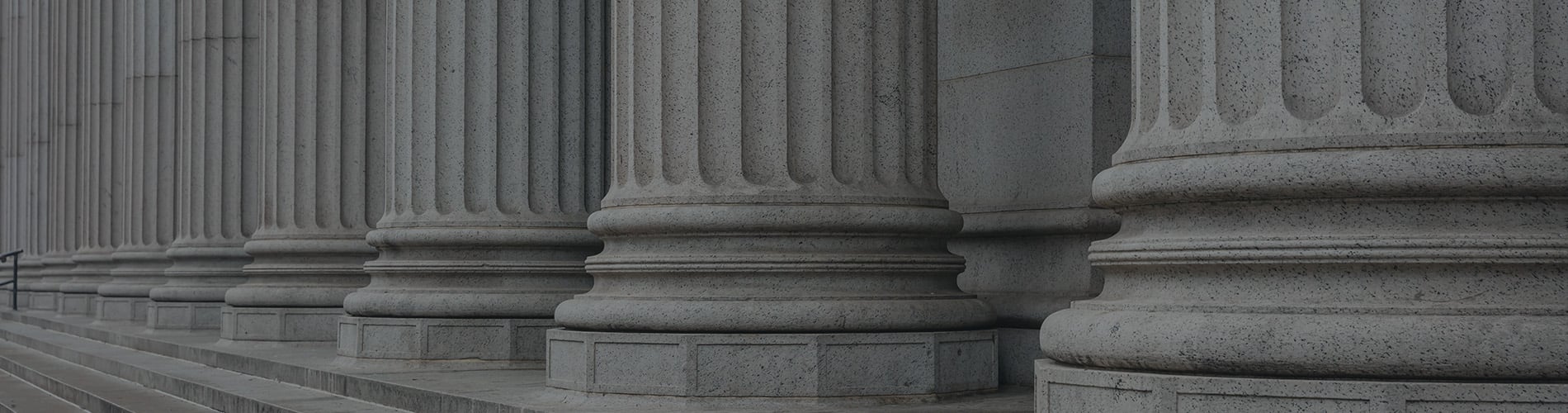 Stone pillars row and stairs detail. Classical building facade