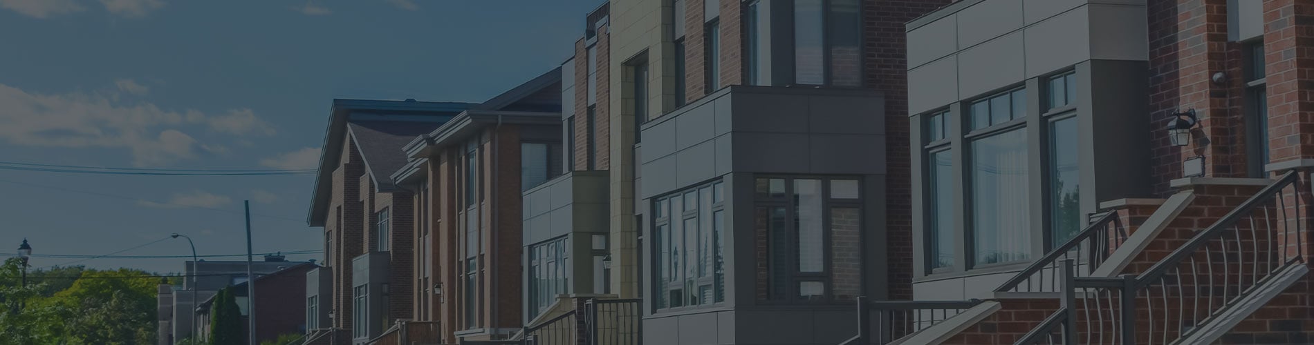 Multi-unit modern housing development with blue sky