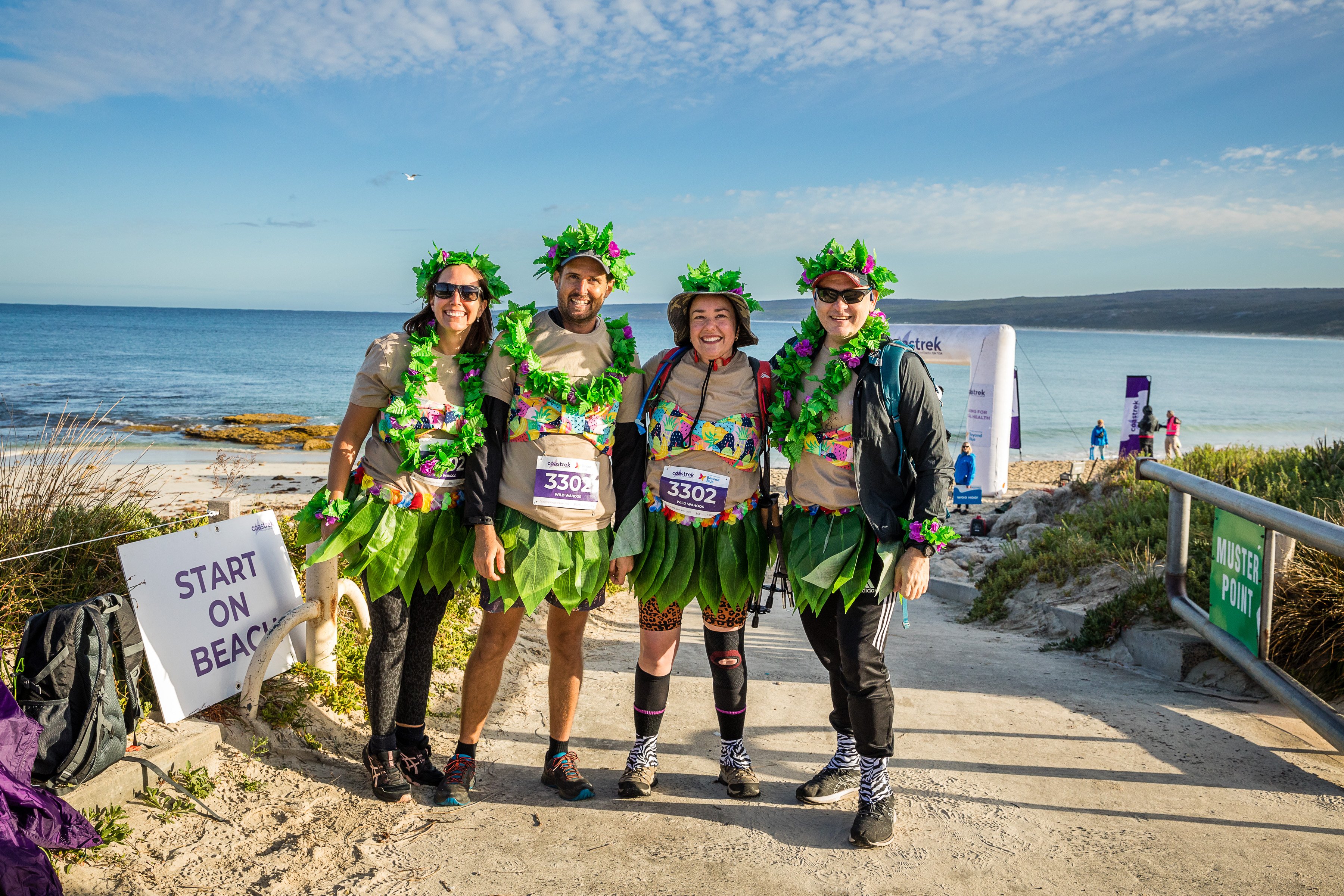 CoastTrek participants stand in front of beach