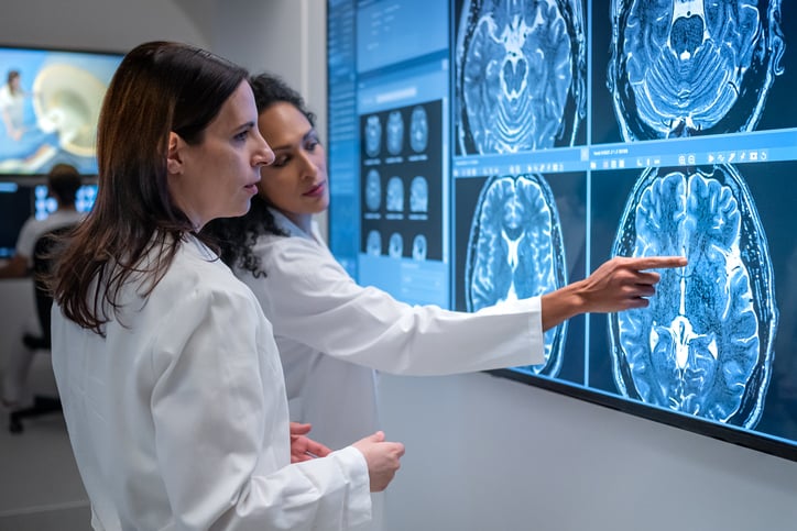 Two doctors looking at brain scans