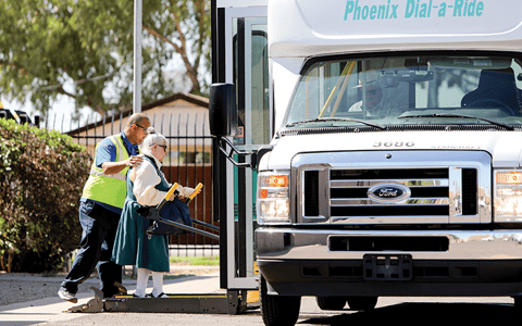 Arizona Center for the Blind & Visually Impaired volunteer helps elderly woman.
