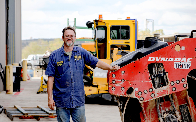 Heavy equipment technician for Closner showcases some of their inventory.