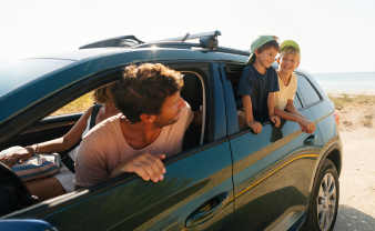Car on the beach with dad and kids