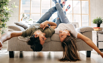 Young couple laying on a chair in their newly renovated home.