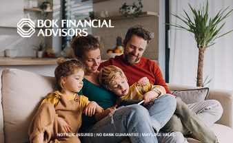 Family together on the couch looking at a tablet.