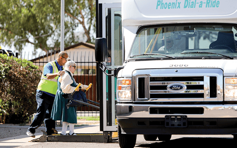 Arizona Center for the Blind & Visually Impaired volunteer helps elderly woman.