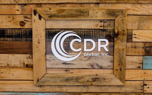 CDR Global logo on wood frame background.
