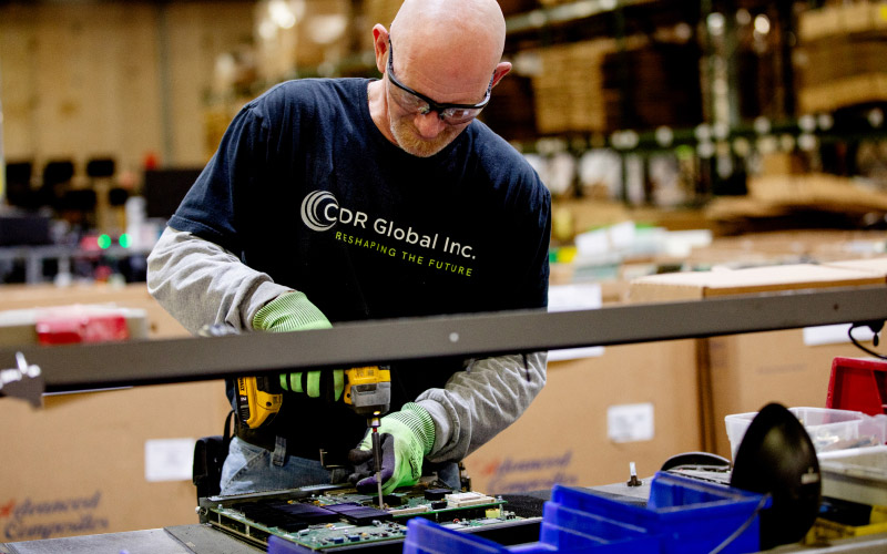 CDR Global tech working on computer circuit board.