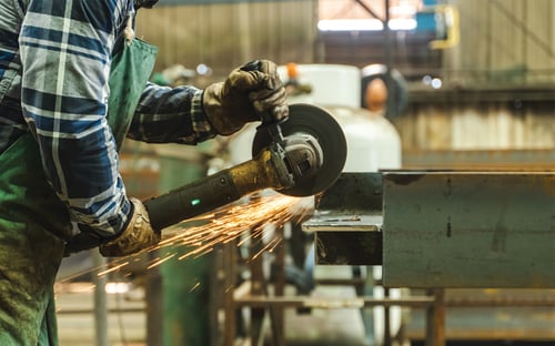 Ennis Steel worker wielding in Dallas, TX warehouse. BOK Financial is proud to partner with Ennis Steel.