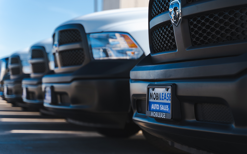 Fleet of Mobilease trucks with branding 