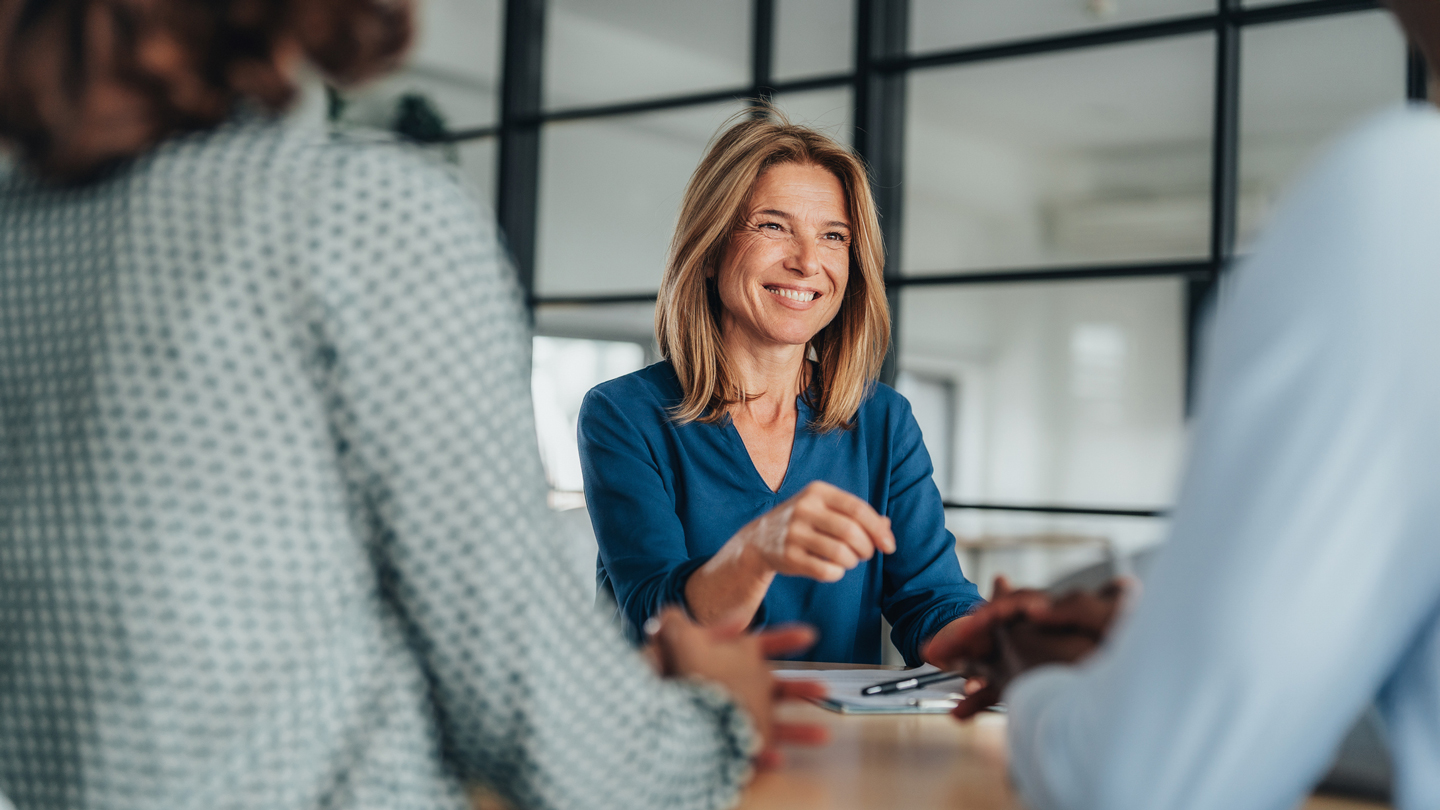 Mortgage banker smiling at a couple