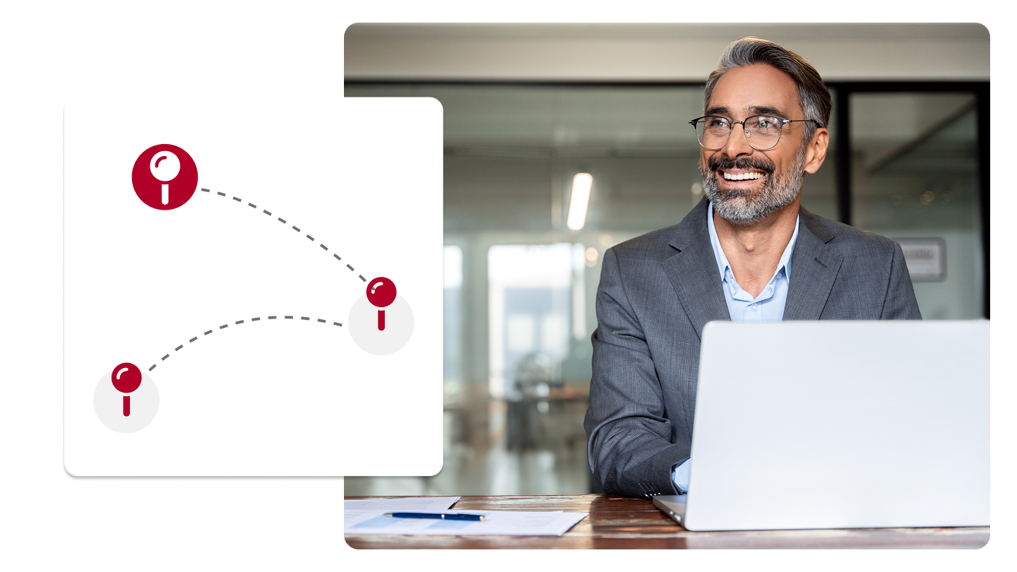 Smiling man typing on a laptop