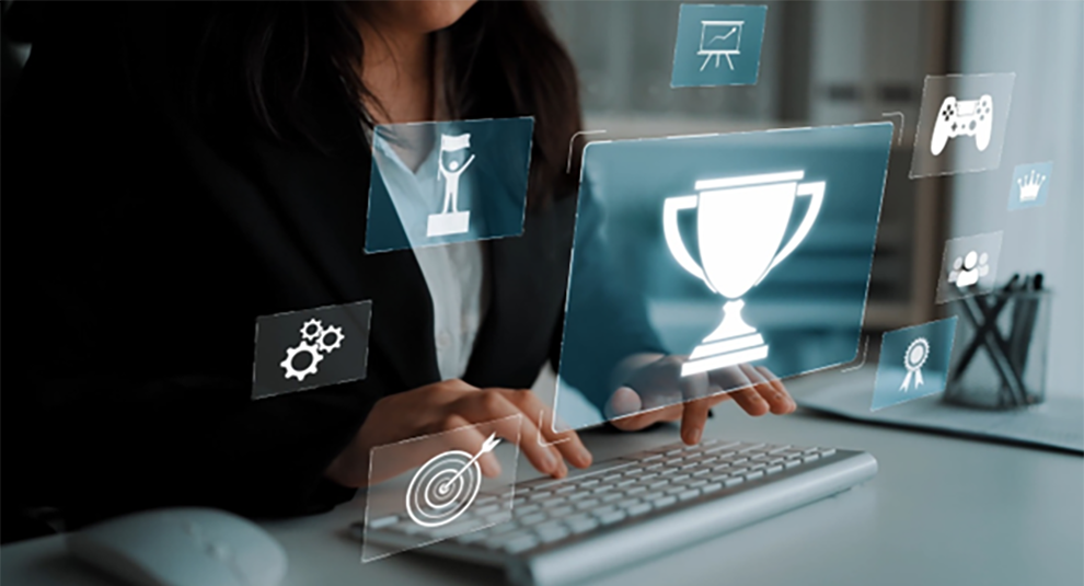 Woman typing on her computer with floating icons of trophy and other awards.