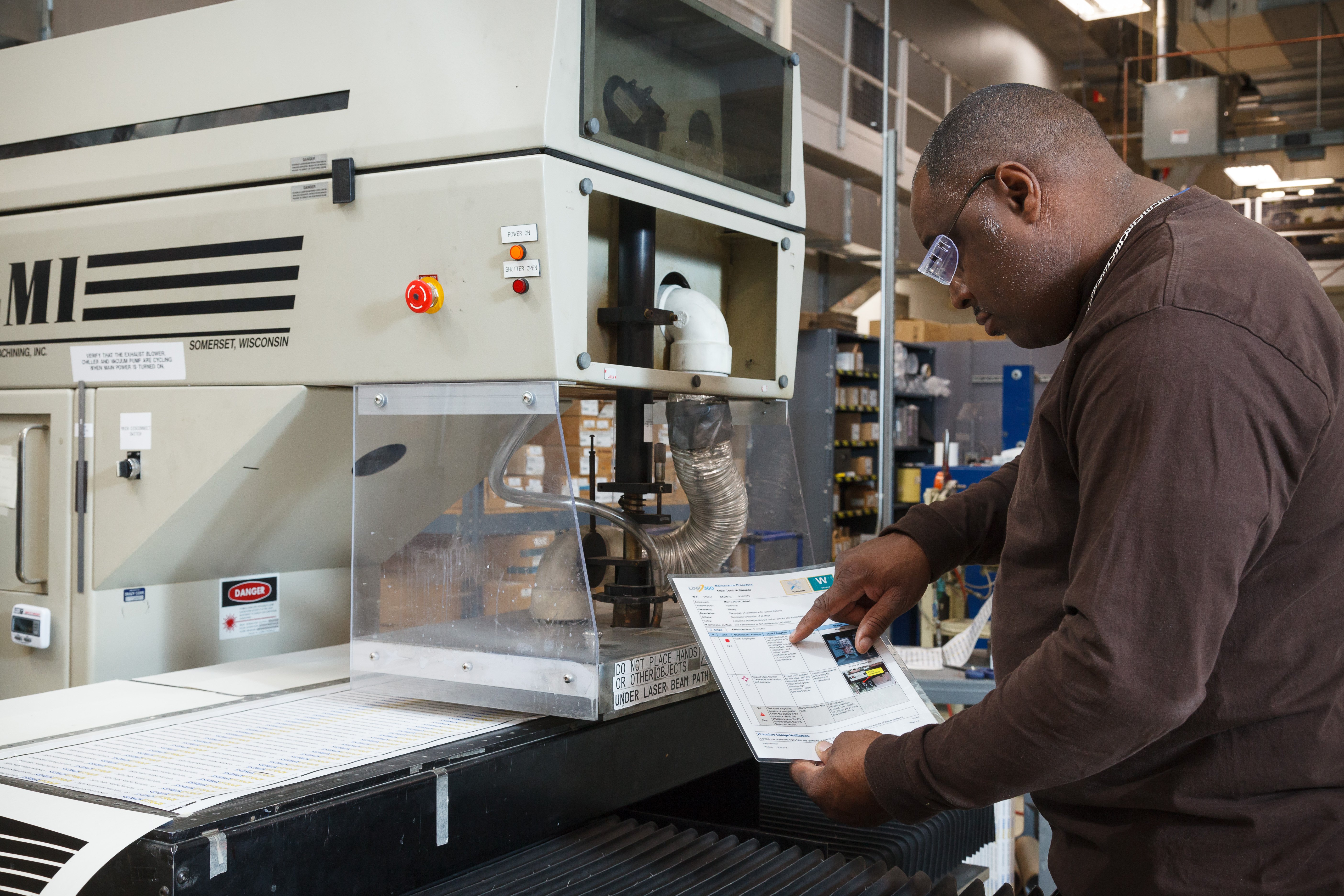 An employee performing a machine quality check.