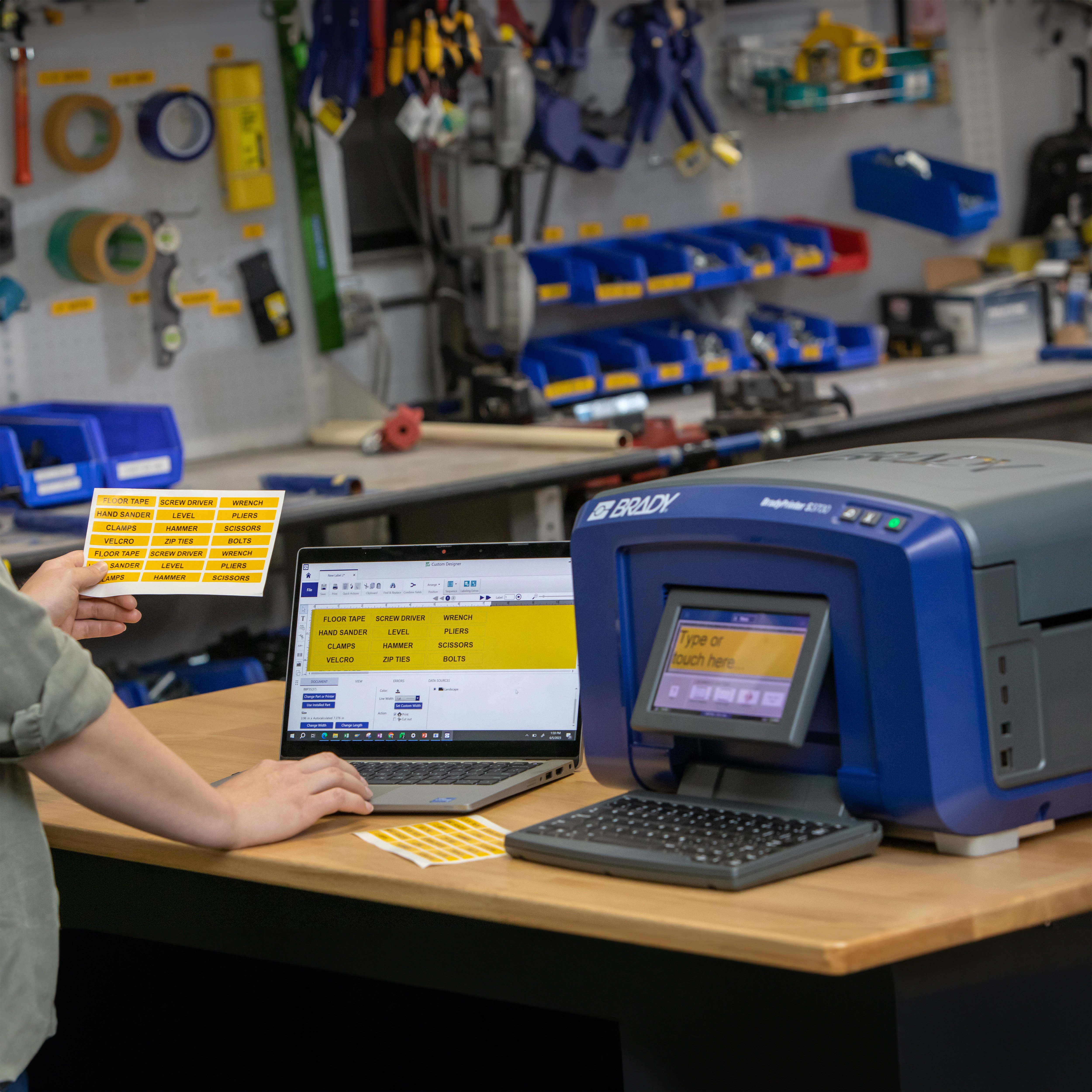 Employee using a Brady S3700 to print labels for lean manufacturing.