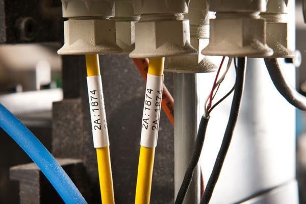 Two yellow wires identified with white wire markers among other wires.