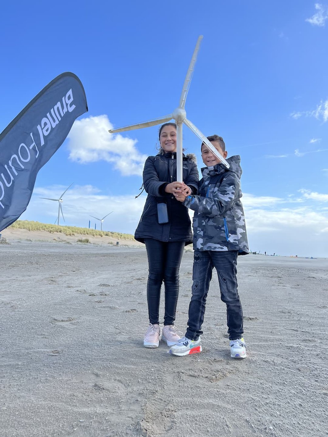 Kids holding a miniature wind turbine