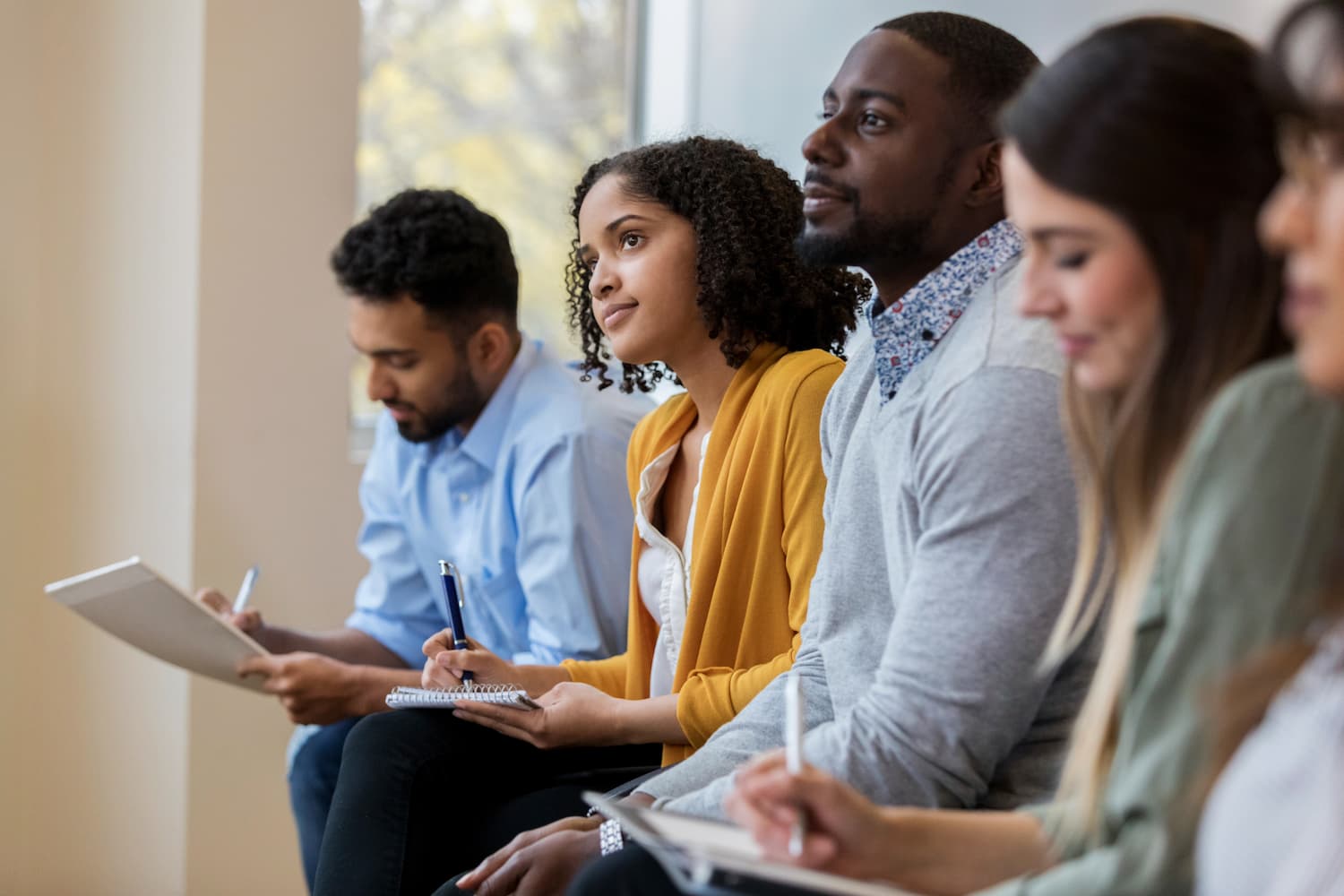 Group of people listening and taking notes