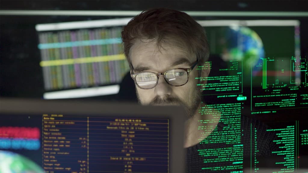 Data information Man behind computer with reflection of data