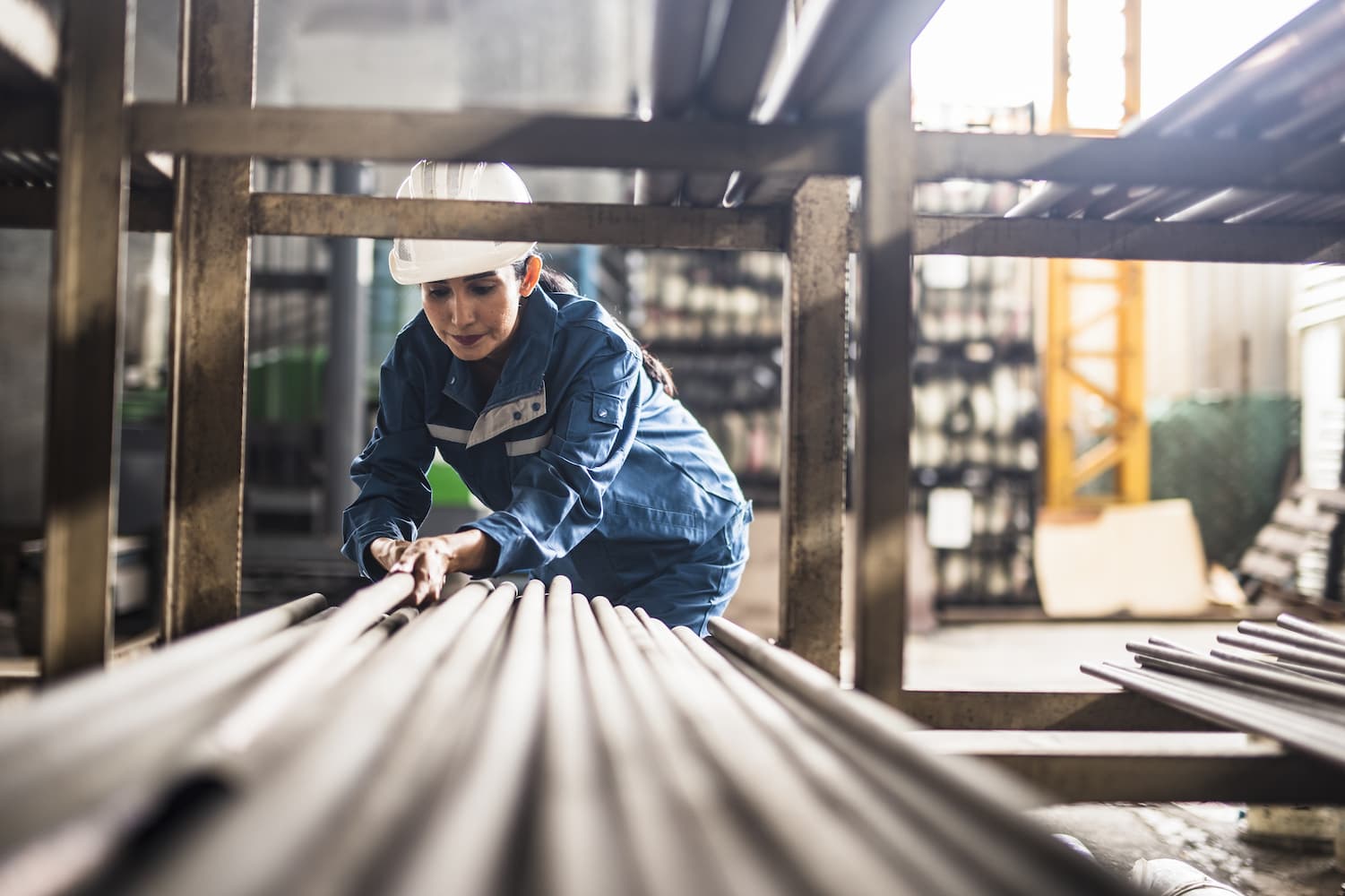 Woman looking at pieces of steel metal