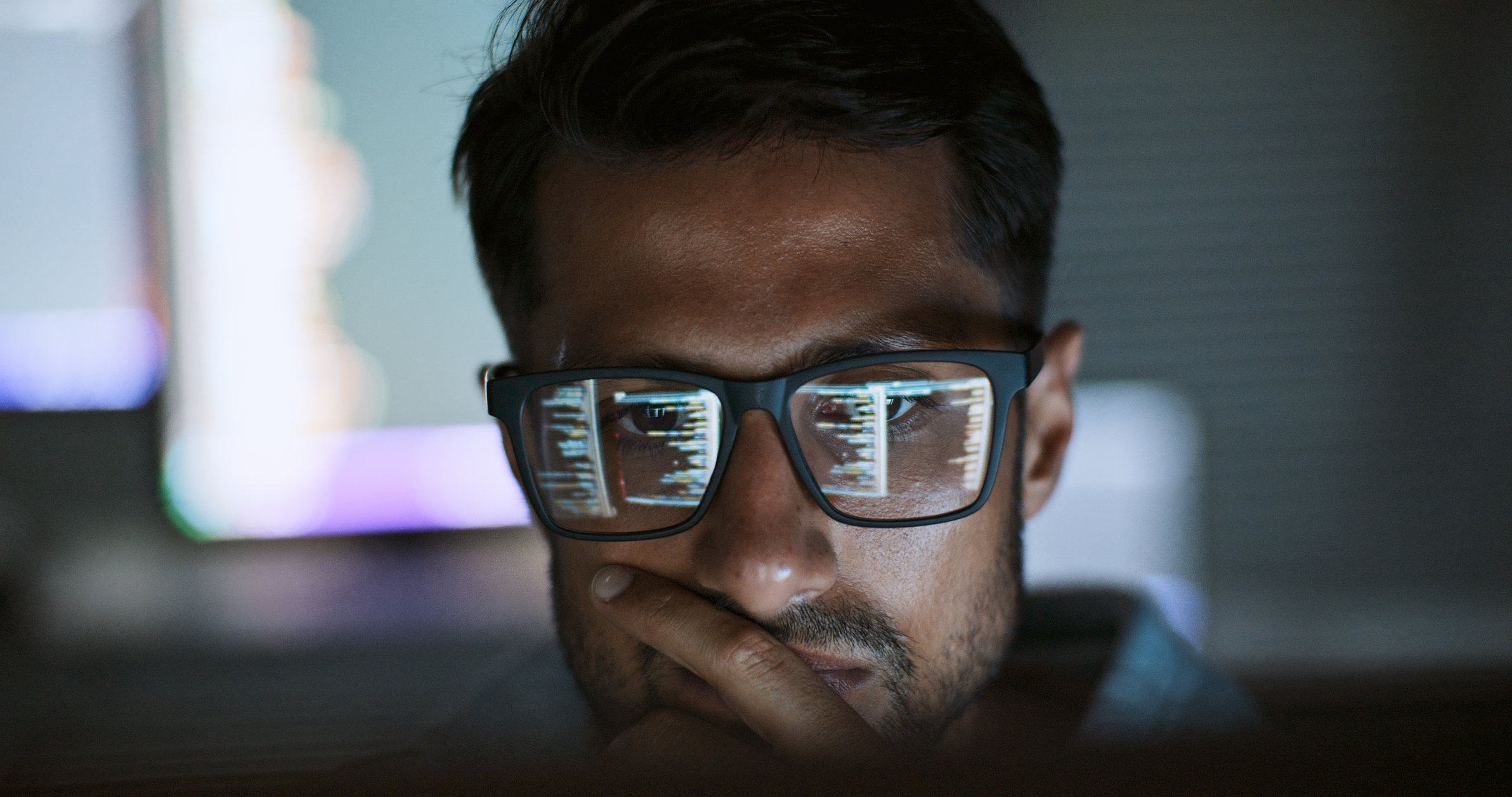 IT consultant focused on a computer screen. IT Hiring Agencies have mastered the art of hiring.