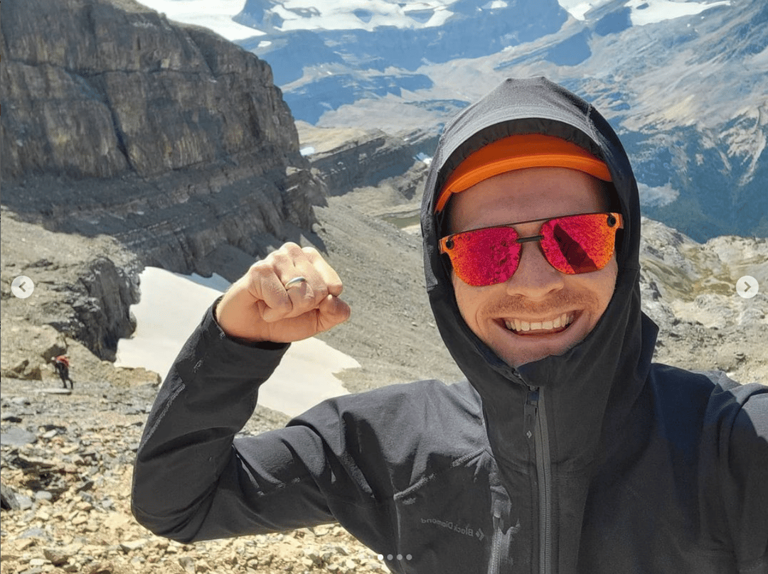 Photo of Dan Cherry in a Winter Coat Standing in a Mountain Range