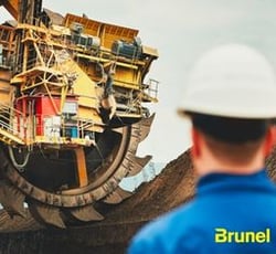 Heavy Equipment Operator looks on at Mining machine