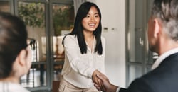 Woman shaking hands with man at job interview