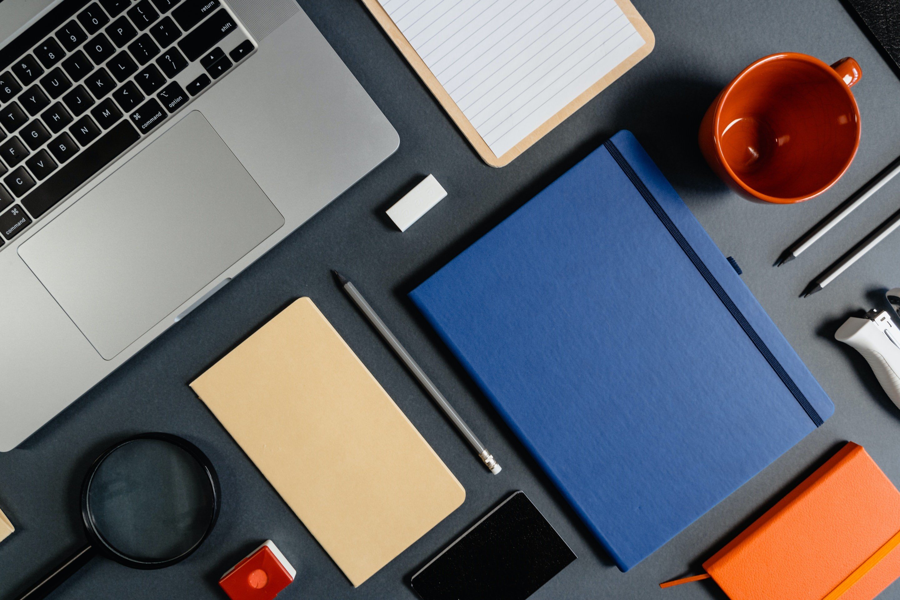 notebooks mugs pencils and a laptop