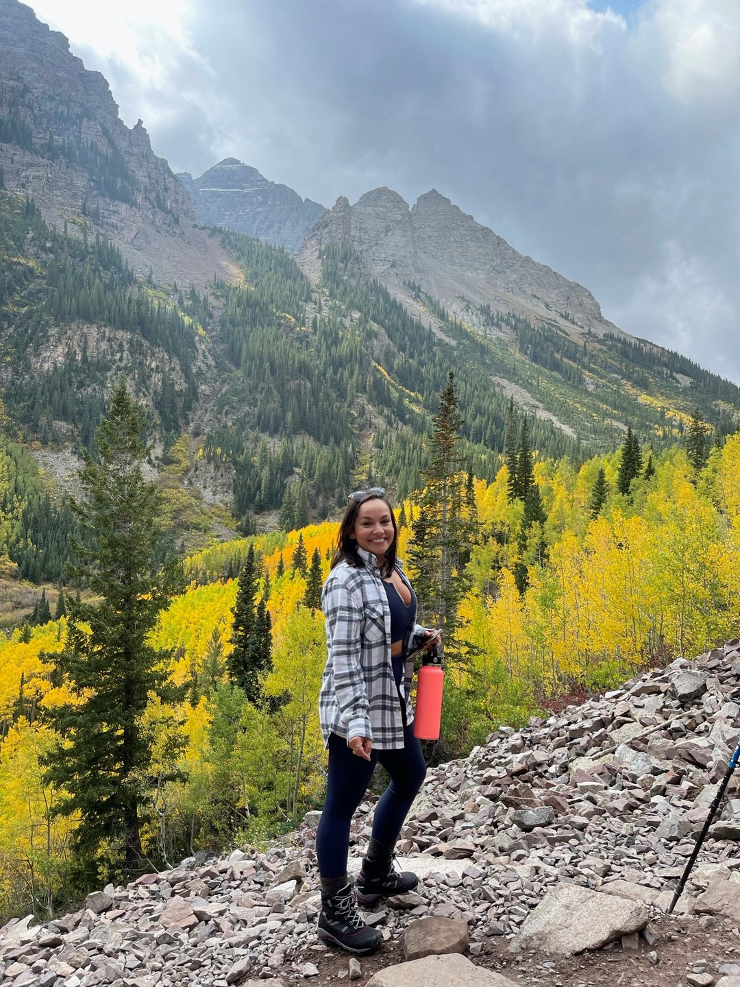 Woman poses in front of a mountain