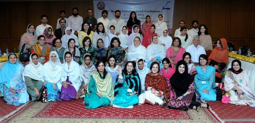 Pakistani men and women posing for a photo