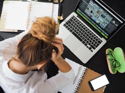 Frustrated woman using laptop