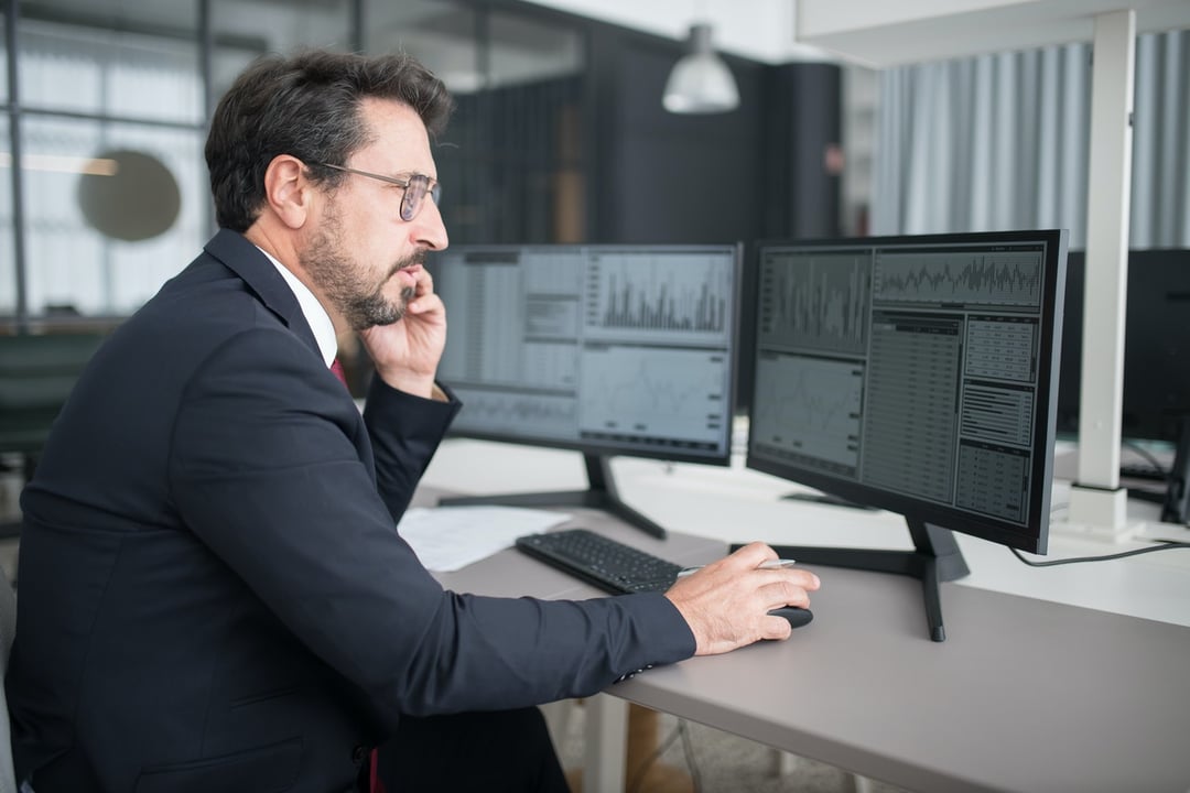 Man working in front of multiple monitors