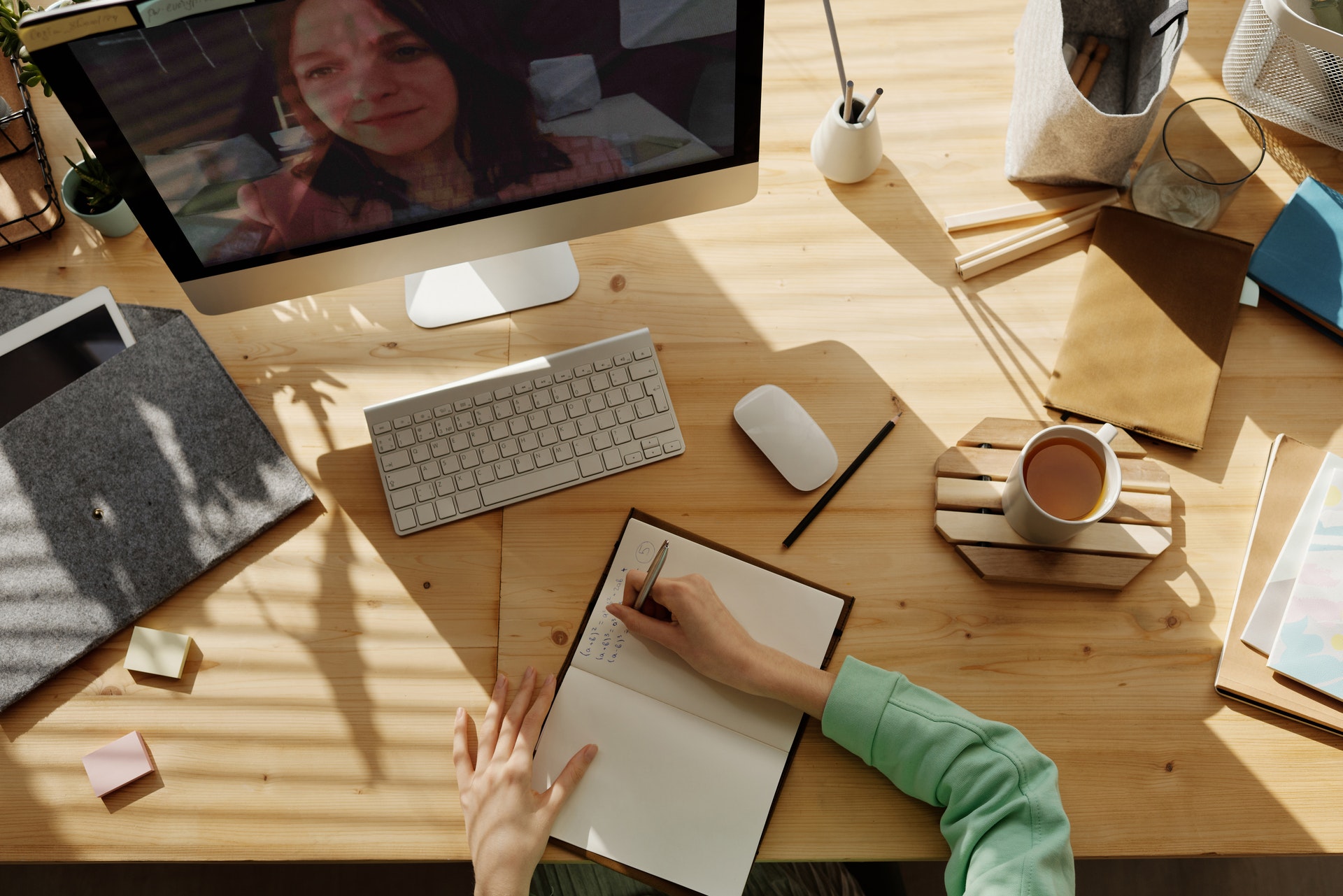 Woman taking notes during video call