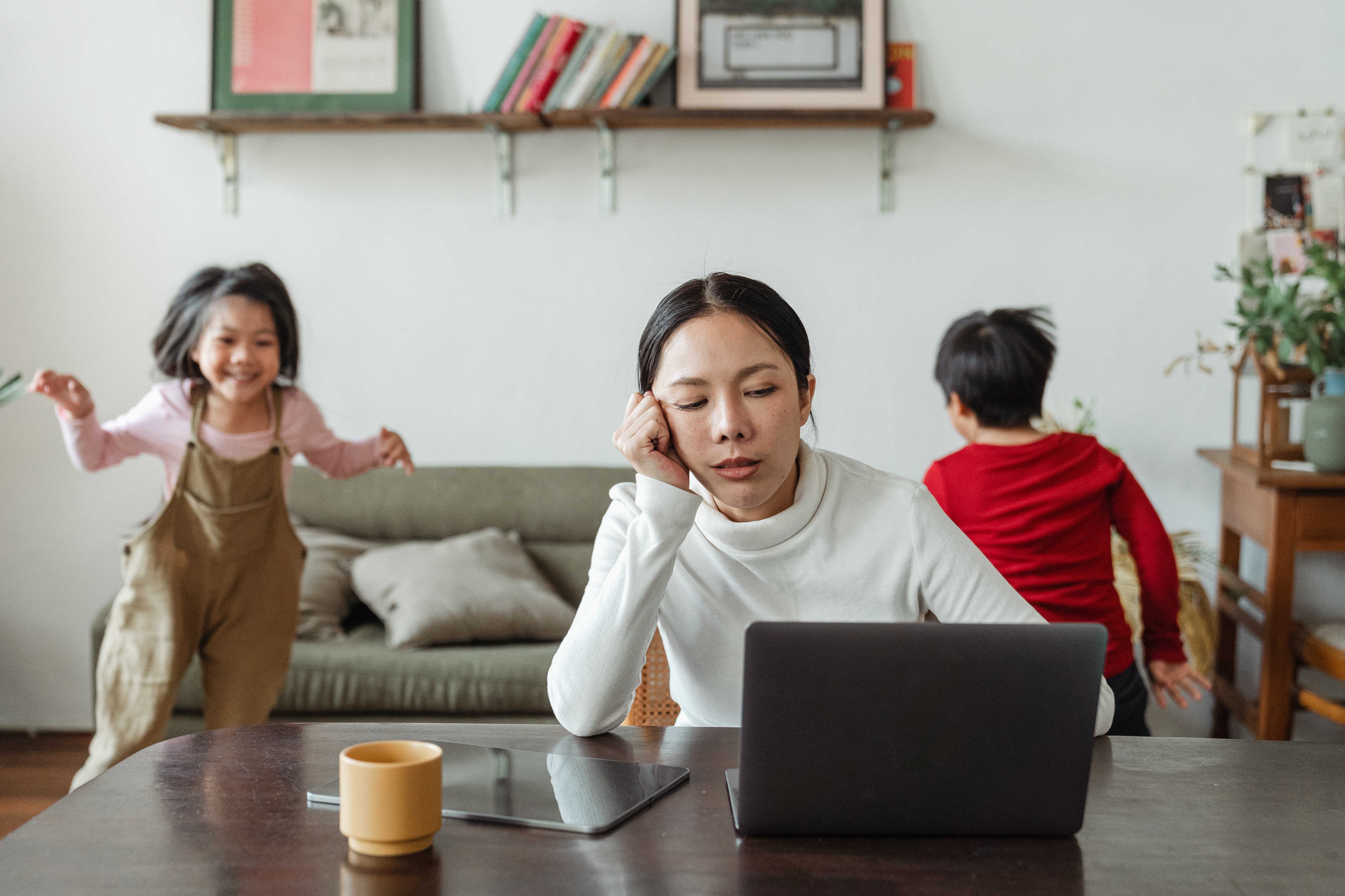 Woman working from home with 2 children