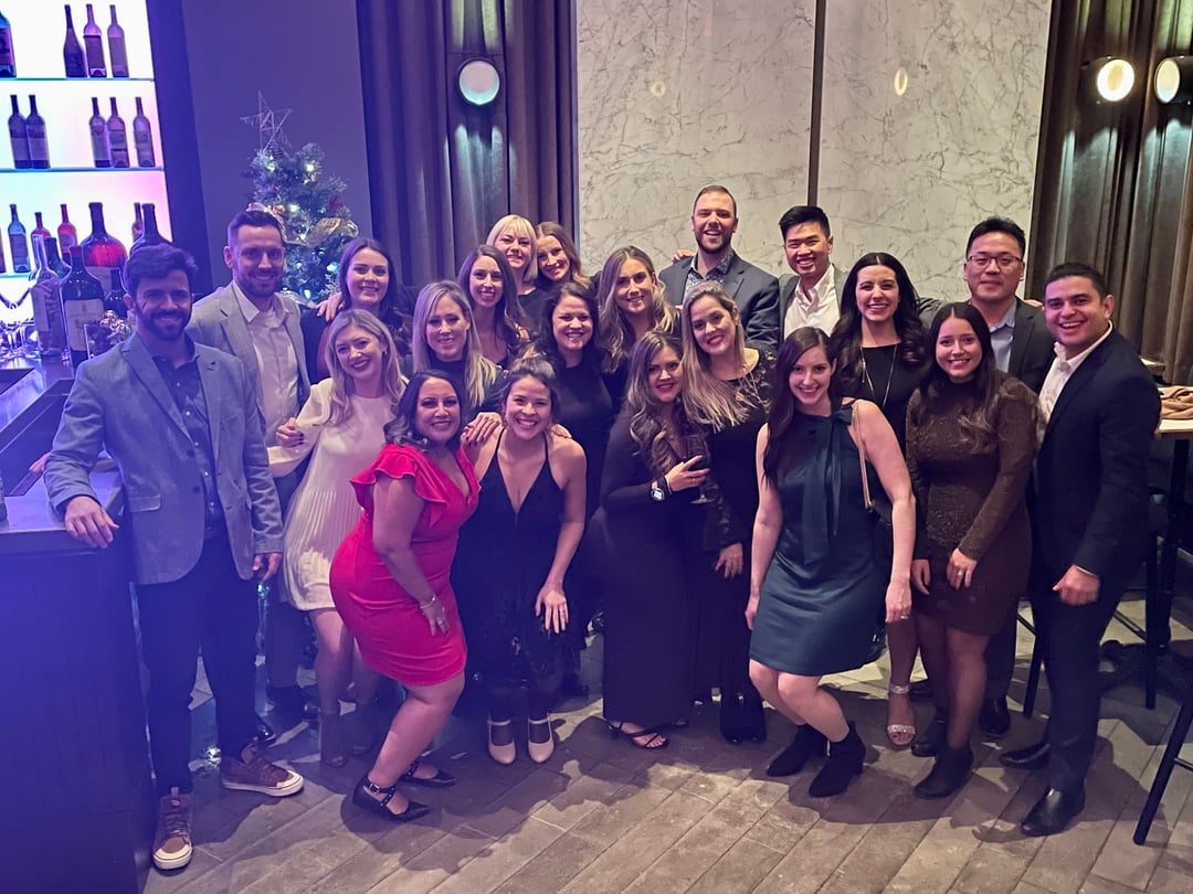 Brunel Canada employees posing for a group picture at an annual holiday party