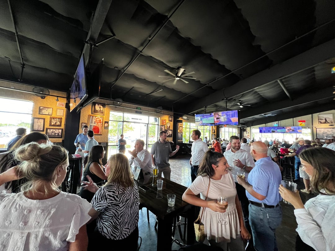 Employees from Brunel's Houston office mingling at happy hour