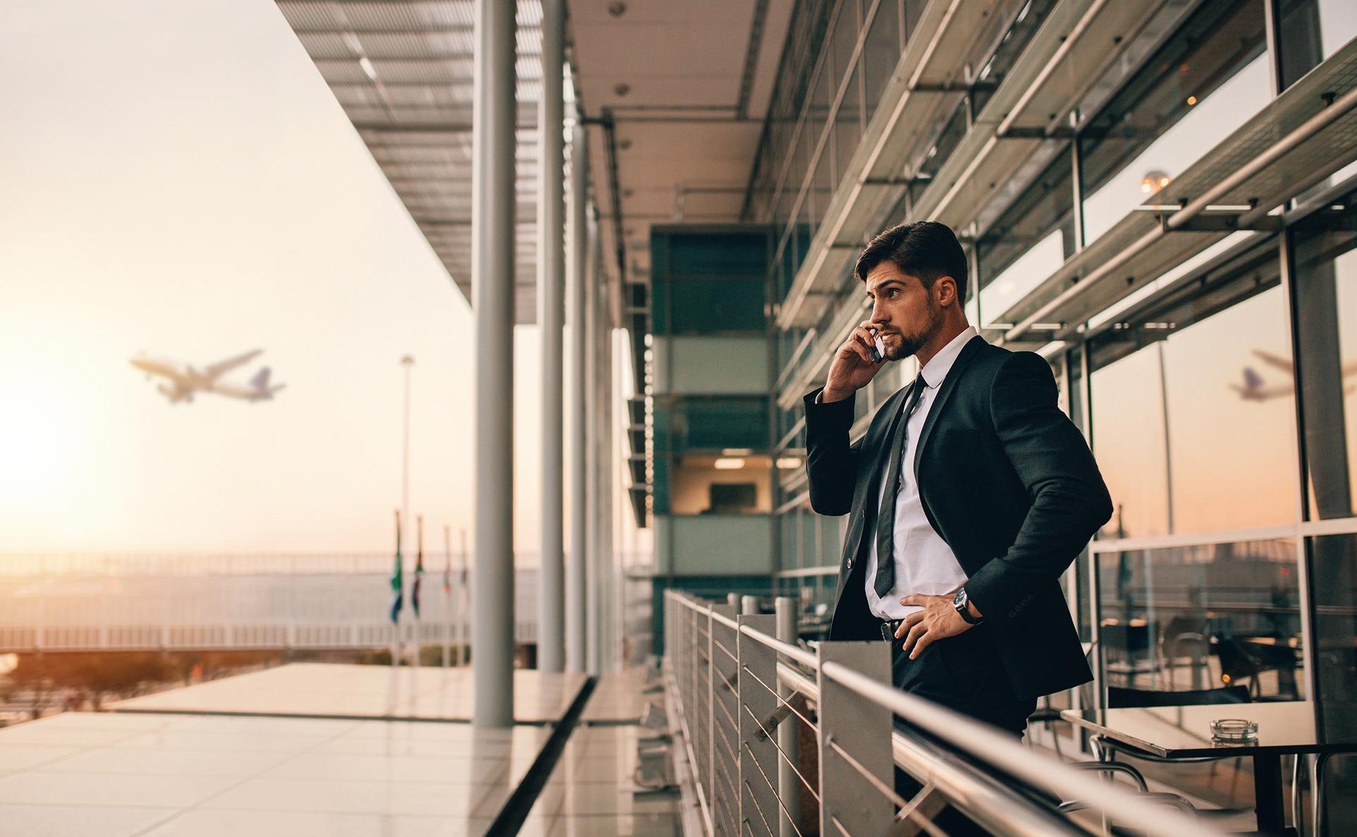 Businessman using phone at airport