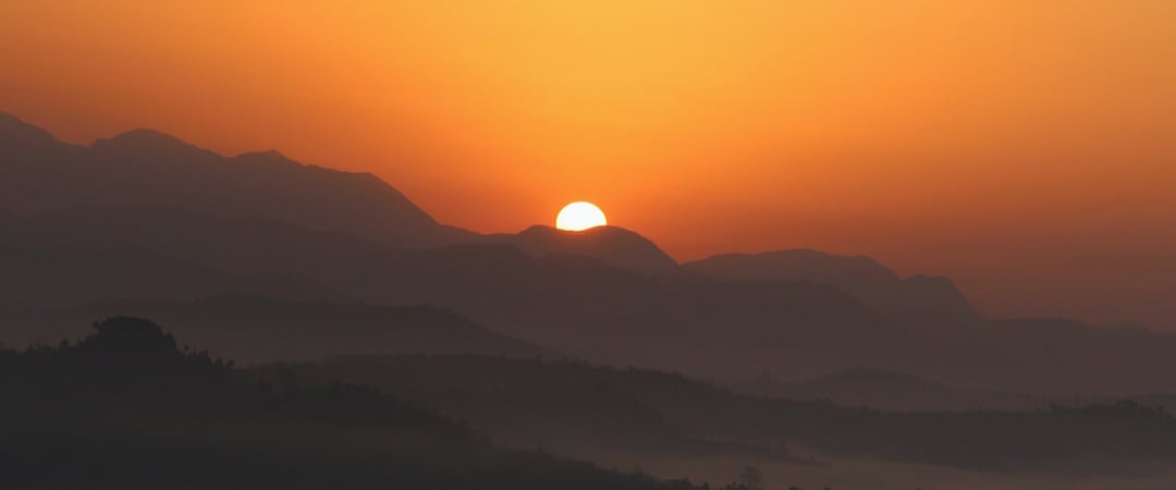 The sun rising over mountains in Nepal