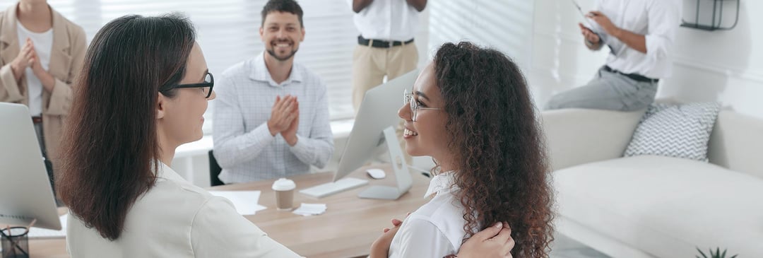 Female boss giving compliment to employee