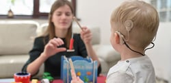 Child with cochlear implant playing